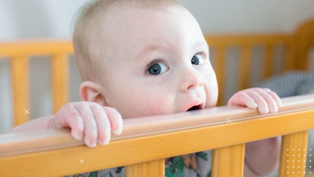 Baby Chewing on Crib 2
