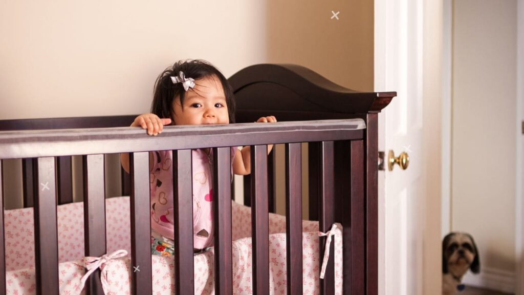 Baby Chewing on Crib 3