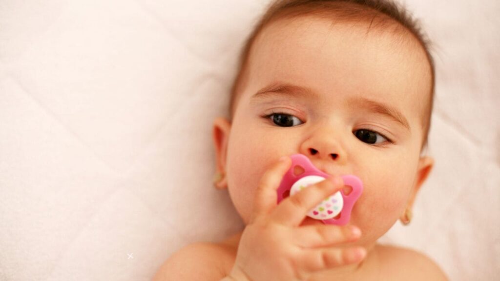 how to keep pacifiers from falling out of crib